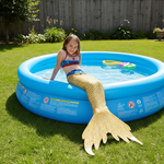 Load image into Gallery viewer, Child in a mermaid tail sitting in an inflatable pool outdoors
