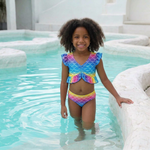 Load image into Gallery viewer, Coco in the pool wearing the Rainbow Scales tankini