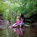 Load image into Gallery viewer, mother and daugher dressed as mermaids sitting by a stream in a forest