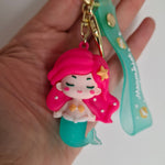 Load image into Gallery viewer, Pink mermaid bag charm with turquoise tail held in hand