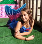 Load image into Gallery viewer, Smiling girl wearing the Rich Blue & Dark Pink Mermaid Tail and Bikini while flipping her tail in the air. Mini Mermaid Tails