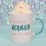 Load image into Gallery viewer, Bone china mug for adult mermaids, white with teal handle, says "Instant Mermaid (in teal colored glitter) just add water" with pink lettering. Mini Mermaid Tails