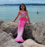 Load image into Gallery viewer, Girl sat on rock by the sea in Mermaid Tail & Pink Shell Bikini 2yrs + - Mini Mermaid Tails