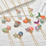 Charger l'image dans la galerie, Pretty enamel mermaid inspired necklaces. Each one has its own intricate charm and are loved by all mini mermaids and adults alike. Shells, starfish, mermaids and mermaid tails in different colors makes these necklaces beautiful. Mini Mermaid Tails