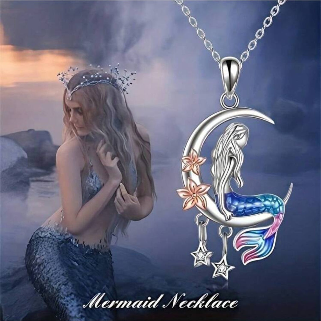 A silver necklace with a crescent moon pendant featuring a mermaid sitting and looking out to the stars, accompanied by the text 'Mermaid Necklace'.