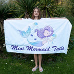 Load image into Gallery viewer, Young girl holding a beach towel that folds up into a bag
