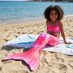 Load image into Gallery viewer, Coco wearing the Candyfloss mermaid tail on the beach