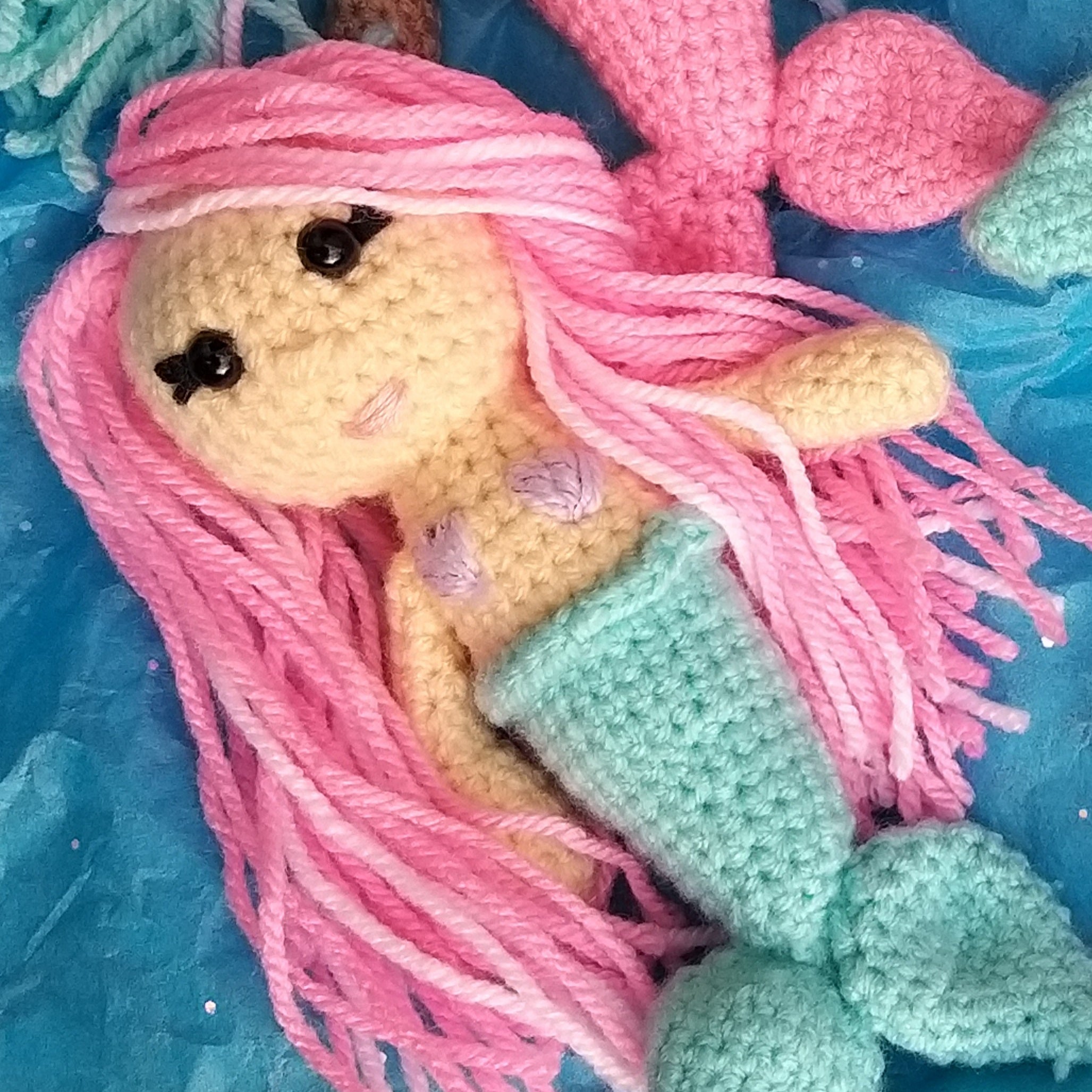 Adorable crocheted mini mermaids toy key rings in pink and teal with hair you can style, varying colored hair, skin and mermaid tails. Mini Mermaid Tails