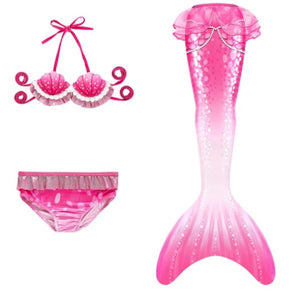 Be pretty in pink with this intricate, slightly padded shell like bikini top. The mermaid tail has a new printed string of pearls design and is finished with a pink netted peplum.  This tail has no fastenings at the bottom so the monofin can be taken on and off easily without stepping out of the whole tail. Mini Mermaid Tails