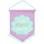 Load image into Gallery viewer, This is a cute purple flag with a triangular bottom with teal colored tassels. On the flag there is a teal colored sea shell that says &quot;A little MERMAID (in glitter) sleeps here&quot;.  Mini Mermaid Tails
