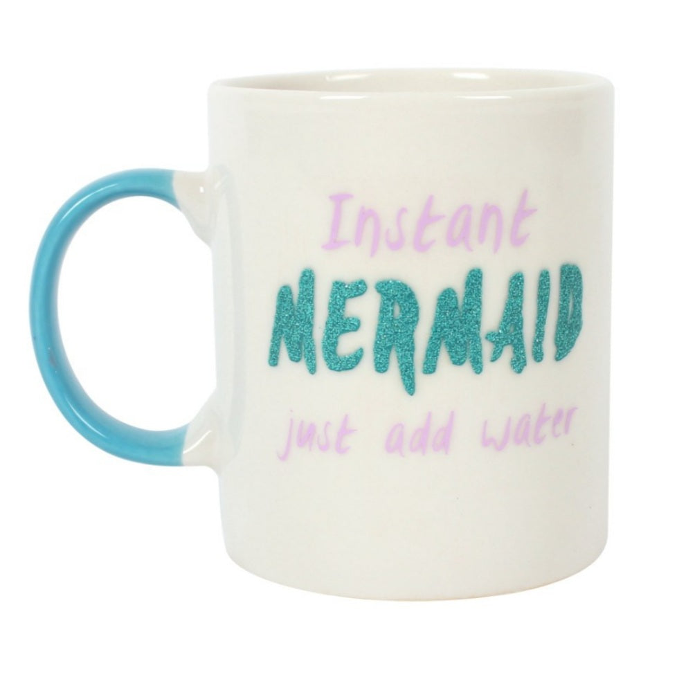 Bone china mug for adult mermaids, white with teal handle, says "Instant Mermaid (in teal colored glitter) just add water" with pink lettering. Mini Mermaid Tails
