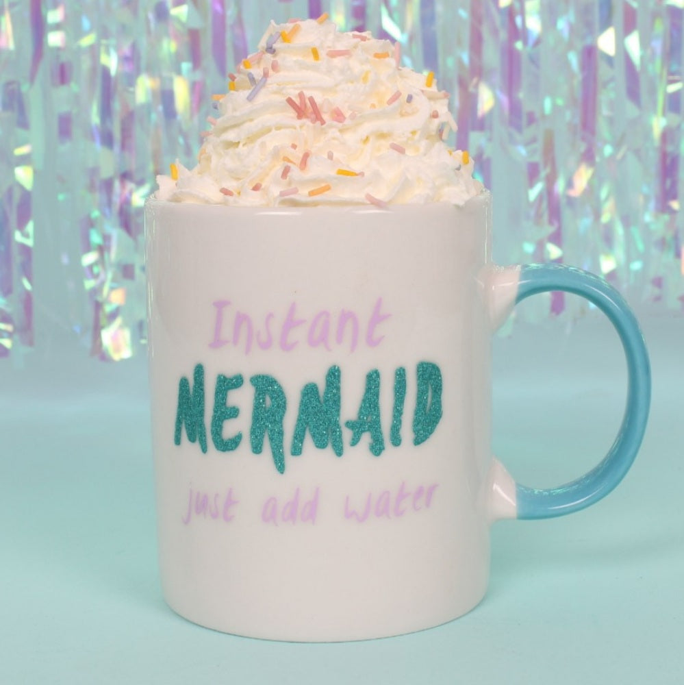 Bone china mug for adult mermaids, white with teal handle, says "Instant Mermaid (in teal colored glitter) just add water" with pink lettering.  Mini Mermaid Tails
