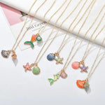 Load image into Gallery viewer, Assortment of beautiful necklaces including charms depicting mermaids, different shells, starfish and mermaid tails with a pearl for kids. Mini Mermaid Tails 
