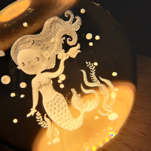 Close up of the etching - Mermaid Crystal Ball 3D LED Nightlight set on a wooden base. Mini Mermaid Tails