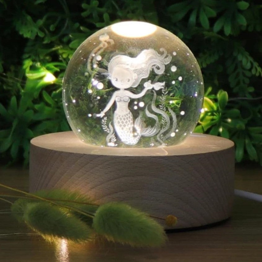 Mermaid Crystal Ball 3D LED Nightlight set on a wooden base. Mini Mermaid Tails