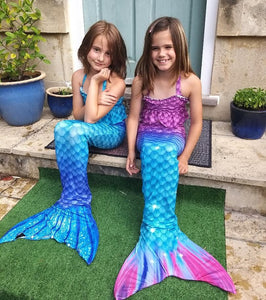 Two happy girls wearing their mermaid tails from Mini Mermaid Tails.