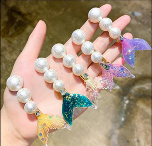 Pastel colored Mermaid Tail Beach Hair Clips with different colored tails and a line of pearls. Mini Mermaid Tails