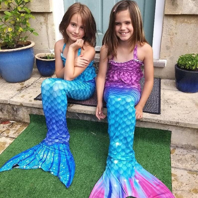 Two happy girls wearing their mermaid tails from Mini Mermaid Tails.