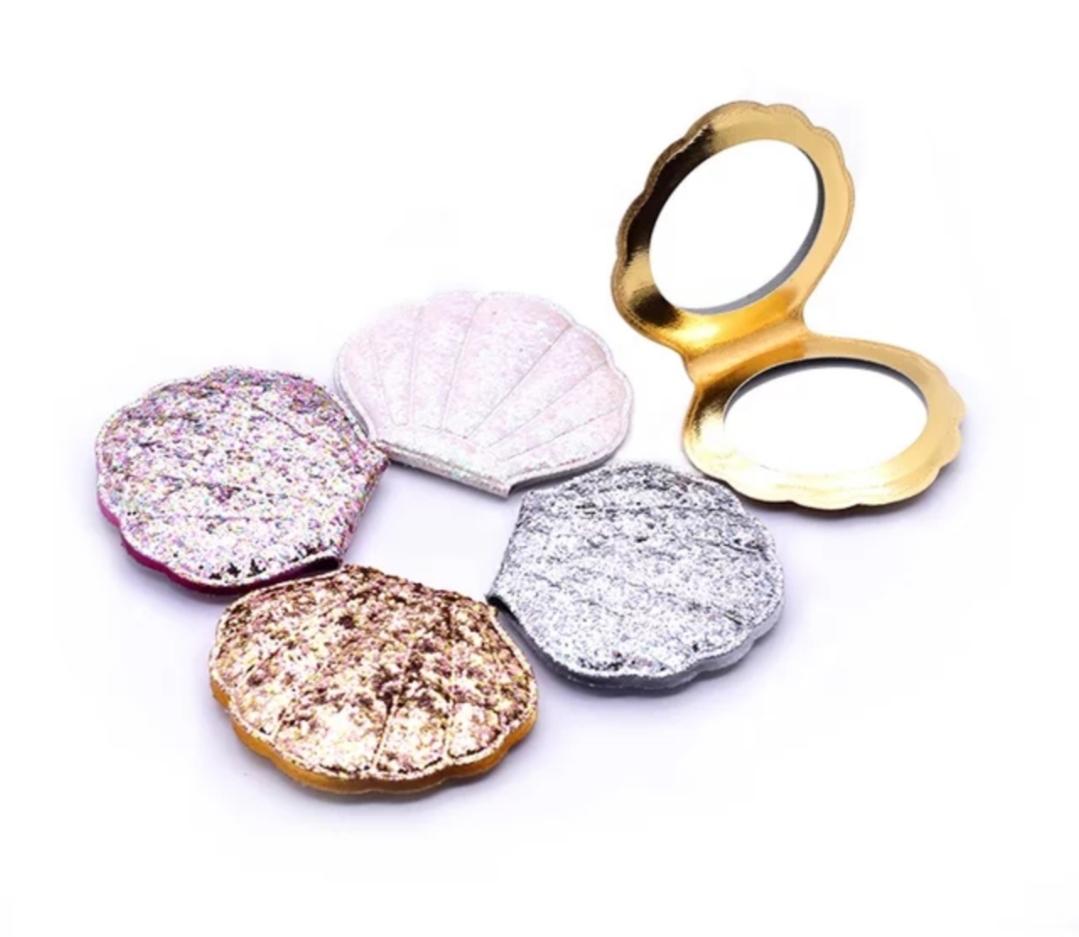 Shell Shaped Mermaid Compact Mirrors for your little Mermaid.  They come in pink, gold, silver, and white. Mini Mermaid Tails