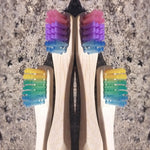 Load image into Gallery viewer, Bamboo toothbrushes in assorted pastel colors.  BPA free, charcoal infused. Mini Mermaid Tails
